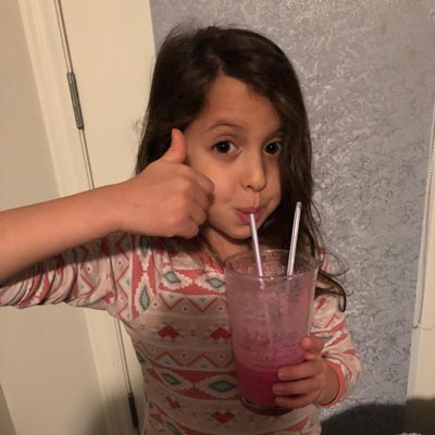 Girl drinking a fruit drink with a straw